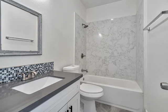 a bathroom with a sink toilet and mirror