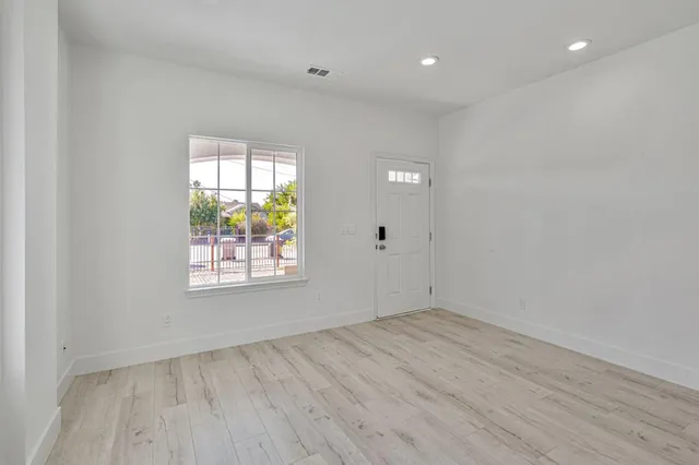 a kitchen with granite countertop a sink cabinets and stainless steel appliances