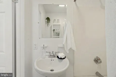 a large bed sitting in a bedroom next to a window and a chair