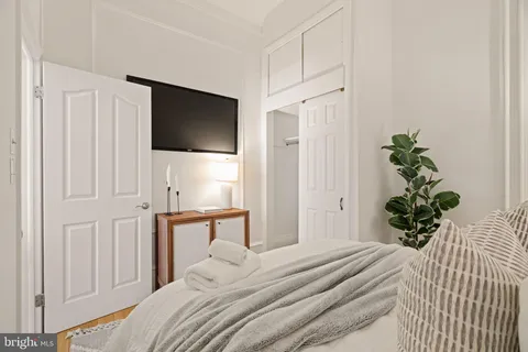 a bedroom with a large bed and a large window