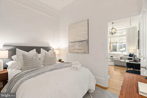 a living room with furniture a table and a large window