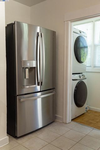 a view of a kitchen with a refrigerator and washer
