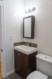 a bathroom with a toilet sink and mirror