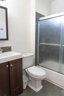 a bathroom with a toilet a sink and shower