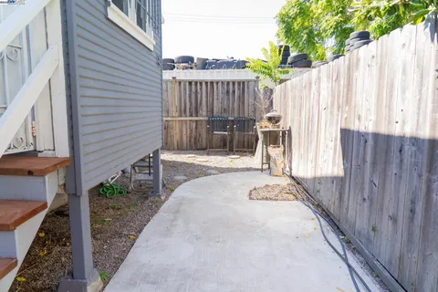 a view of a backyard with wooden fence