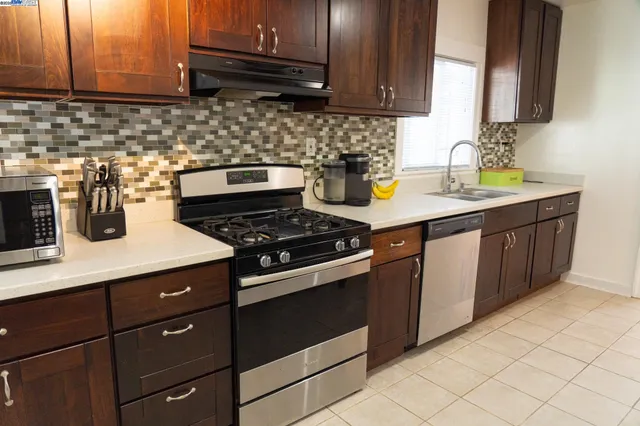 a kitchen with sink and cabinets