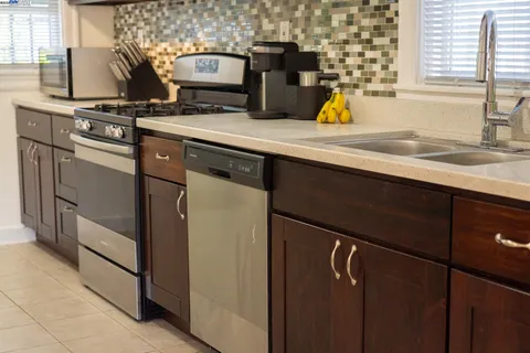 a kitchen with a sink appliances and cabinets
