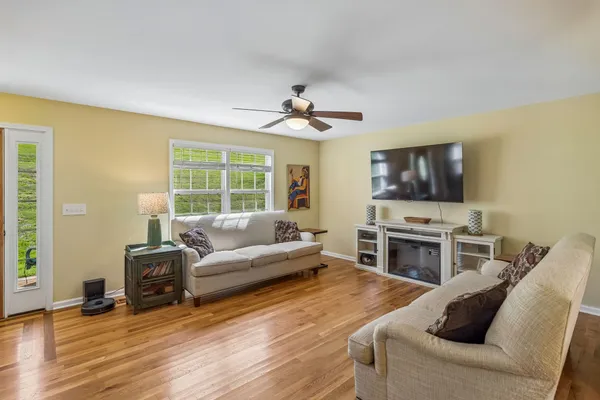 a living room with furniture flat screen tv and a fireplace