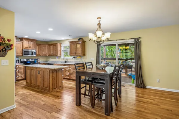 a kitchen with granite countertop a sink a stove and cabinets