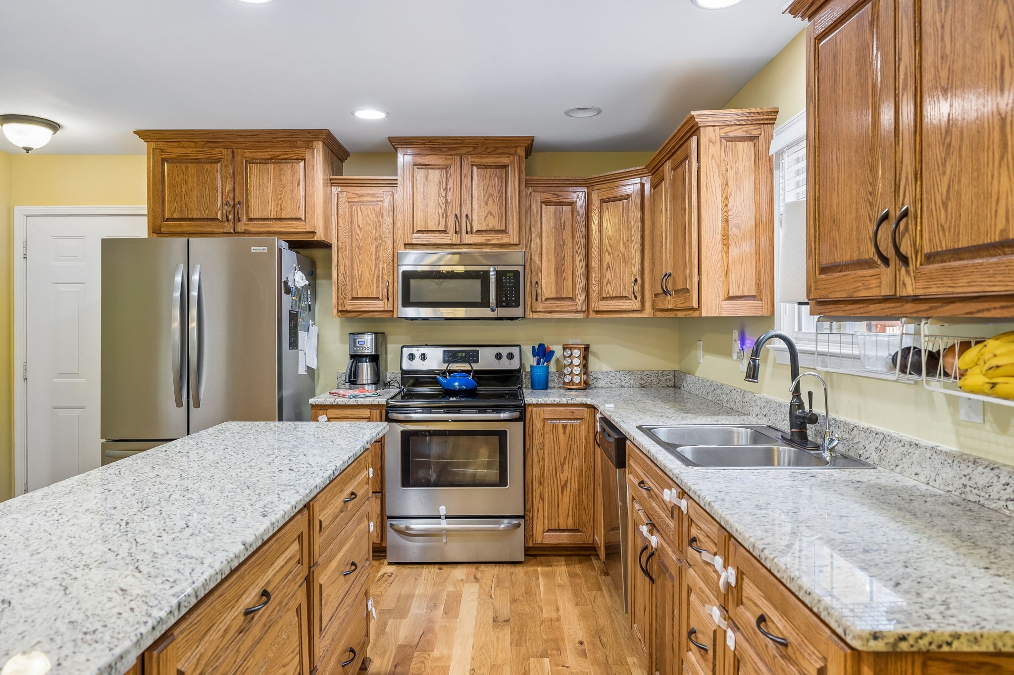 1548 Heller Ridge Spring Hill, TN 37174 - Photo 20 of 73 a kitchen with stainless steel appliances granite countertop a sink stove and refrigerator