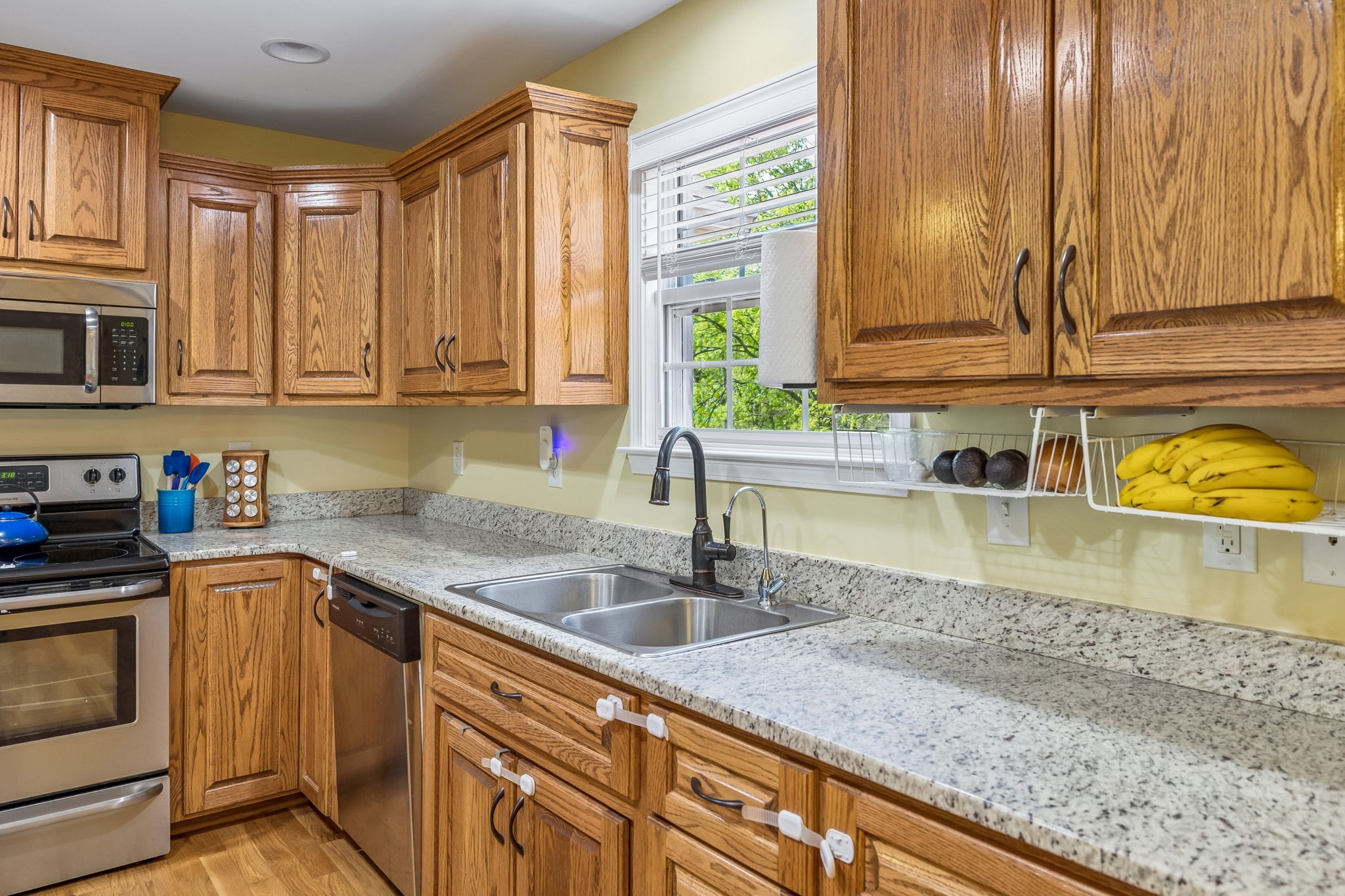 1548 Heller Ridge Spring Hill, TN 37174 - Photo 21 of 73 a kitchen with granite countertop a sink a stove and cabinets