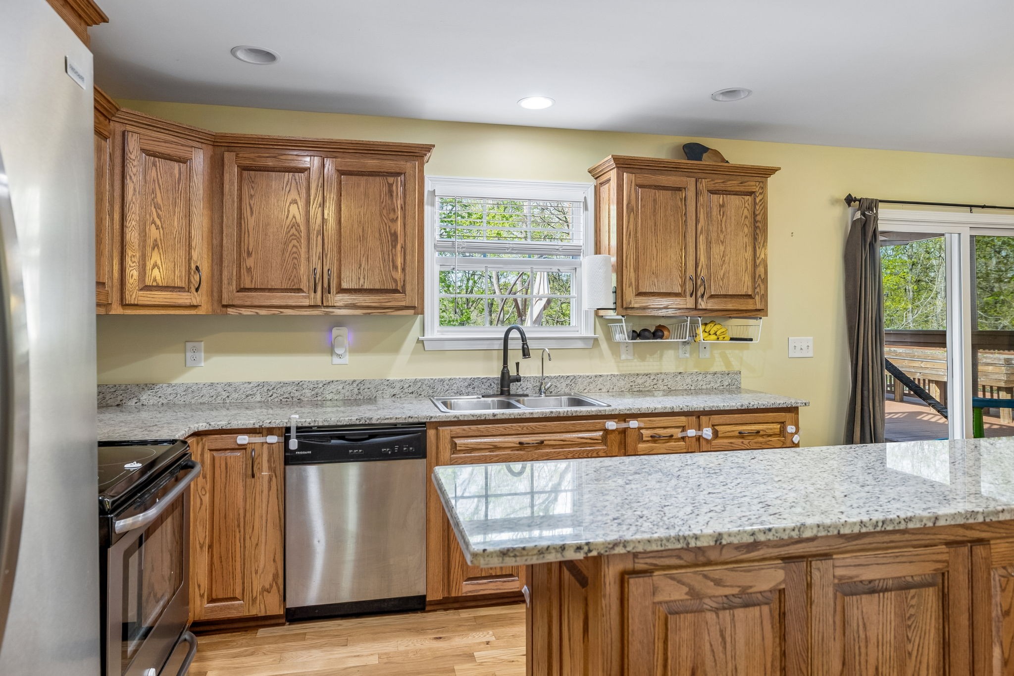 1548 Heller Ridge Spring Hill, TN 37174 - Photo 22 of 73 a kitchen with granite countertop a sink a counter space and stainless steel appliances