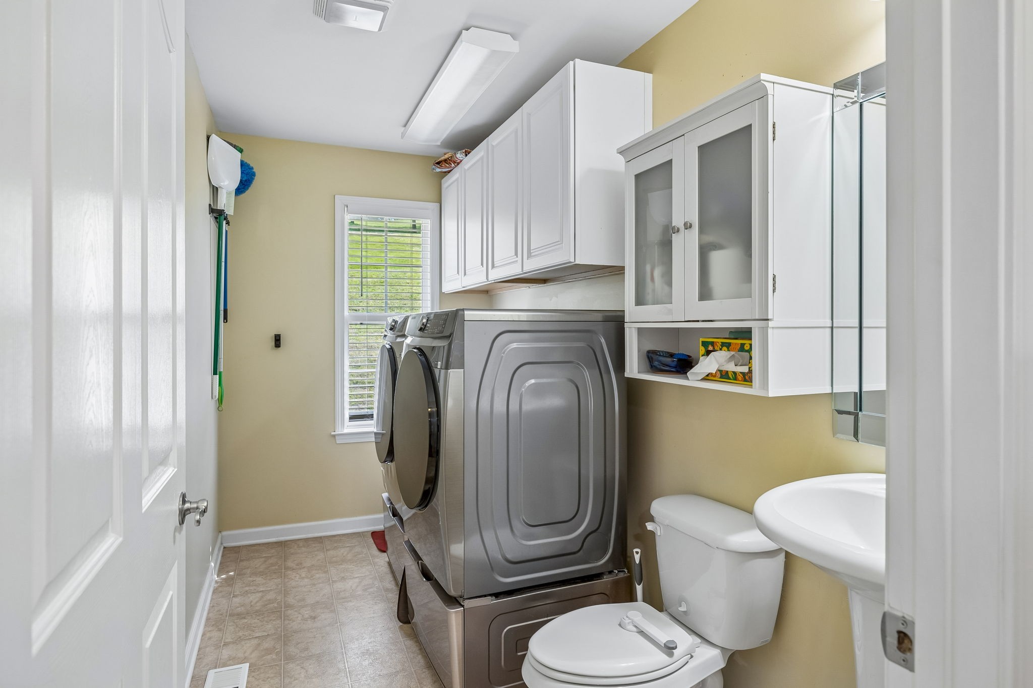 1548 Heller Ridge Spring Hill, TN 37174 - Photo 24 of 73 a white toilet sitting next to a bathroom sink and a window
