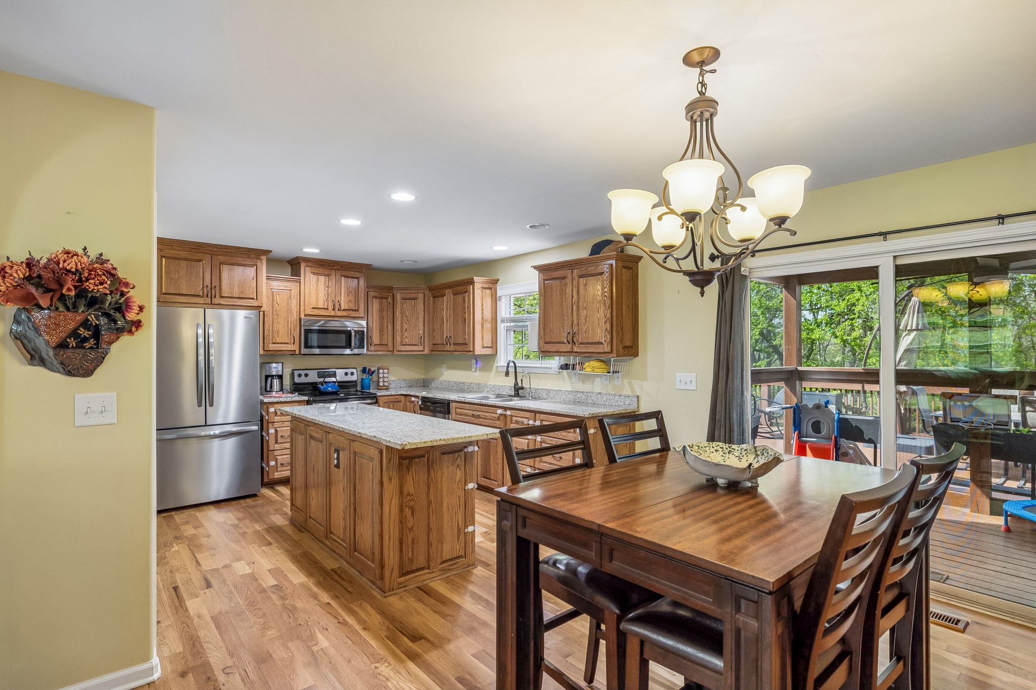 1548 Heller Ridge Spring Hill, TN 37174 - Photo 30 of 73 a view of a dining room with furniture a chandelier and wooden floor