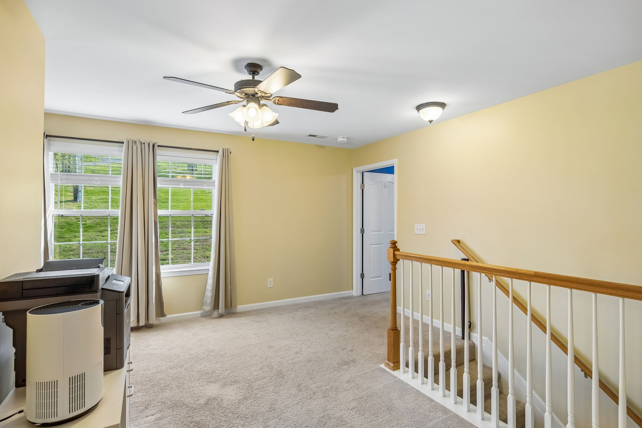 1548 Heller Ridge Spring Hill, TN 37174 - Photo 36 of 73 a view of a livingroom with wooden floor and a ceiling fan