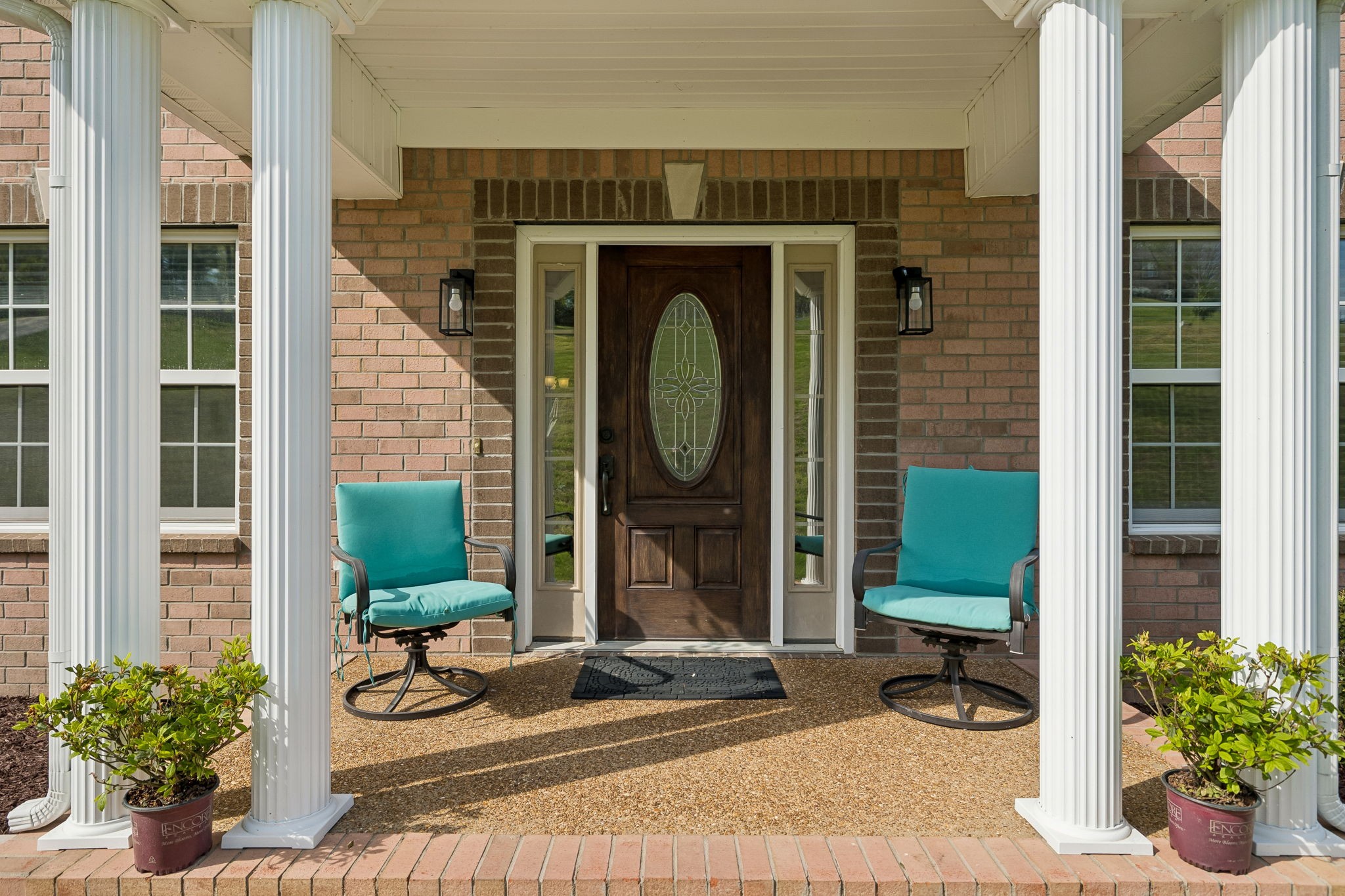 1548 Heller Ridge Spring Hill, TN 37174 - Photo 4 of 73 a front view of a house with outdoor seating and plants
