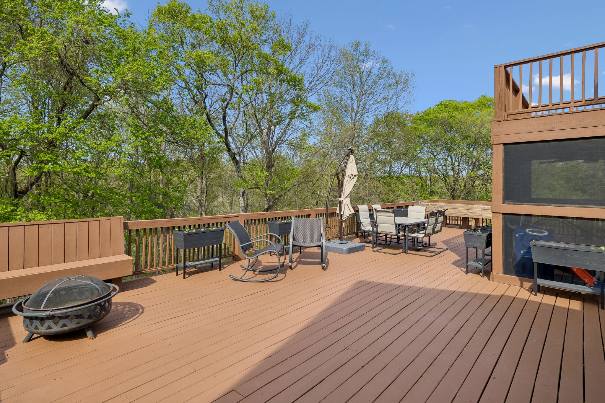 1548 Heller Ridge Spring Hill, TN 37174 - Photo 48 of 73 a view of a roof deck with table and chairs a barbeque with wooden floor and fence