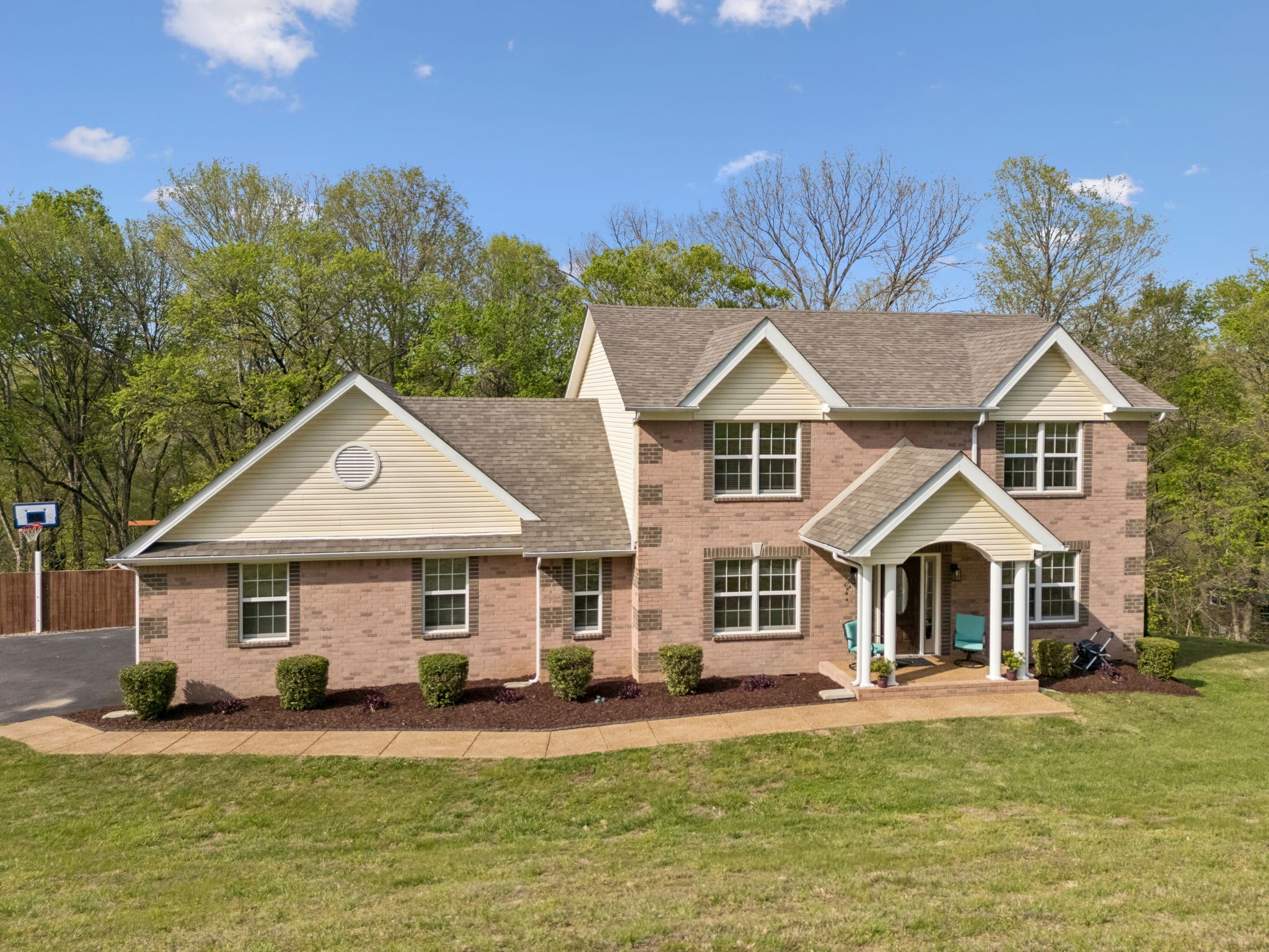 1548 Heller Ridge Spring Hill, TN 37174 - Photo 55 of 73 a front view of a house with a yard table and chairs