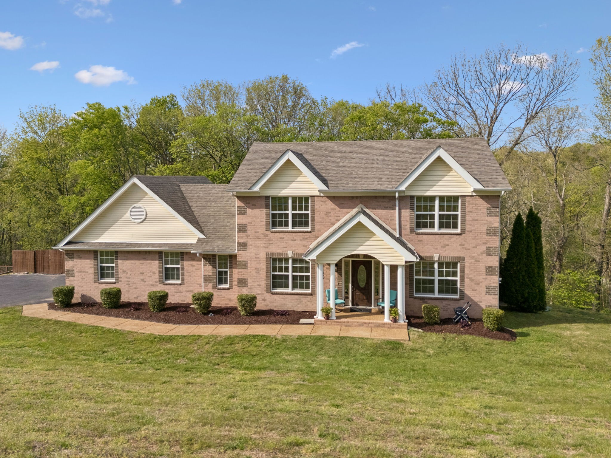 1548 Heller Ridge Spring Hill, TN 37174 - Photo 57 of 73 a front view of a house with a yard table and chairs