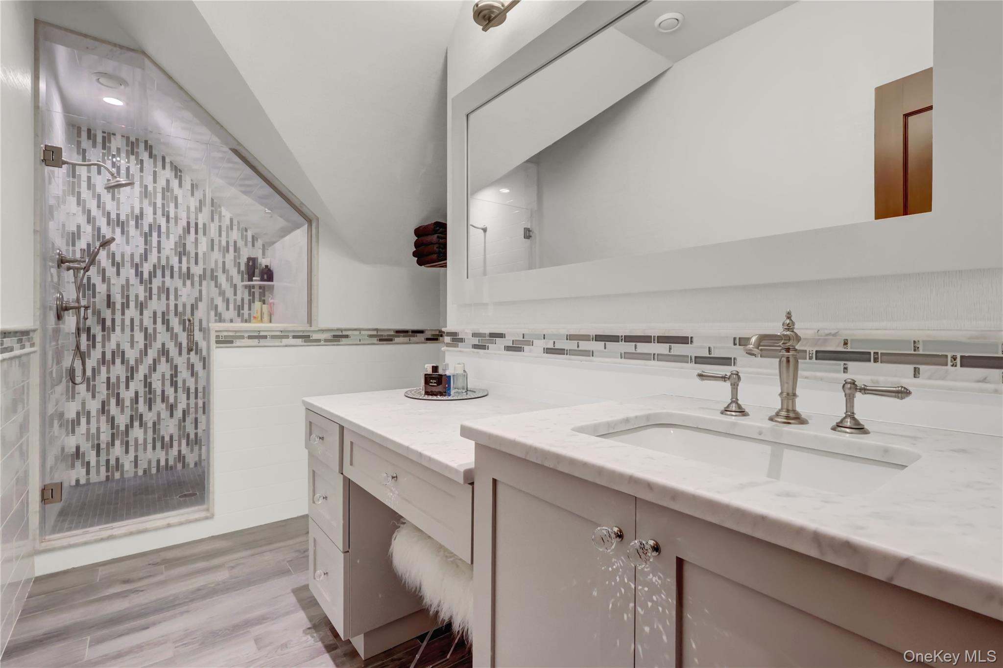 63 Dyke Road Setauket, NY 11733 - Photo 34 of 49 Bathroom with a stall shower, vanity, and light wood-type flooring