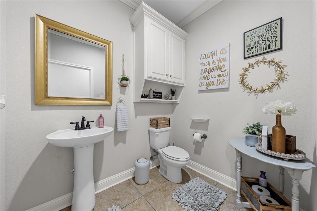 201 Camino Del Rancho Lorena, TX 76655 - Photo 17 of 35 a bathroom with a toilet sink and mirror