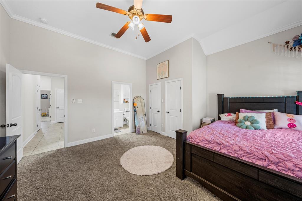201 Camino Del Rancho Lorena, TX 76655 - Photo 23 of 35 a bedroom with a bed and a chandelier