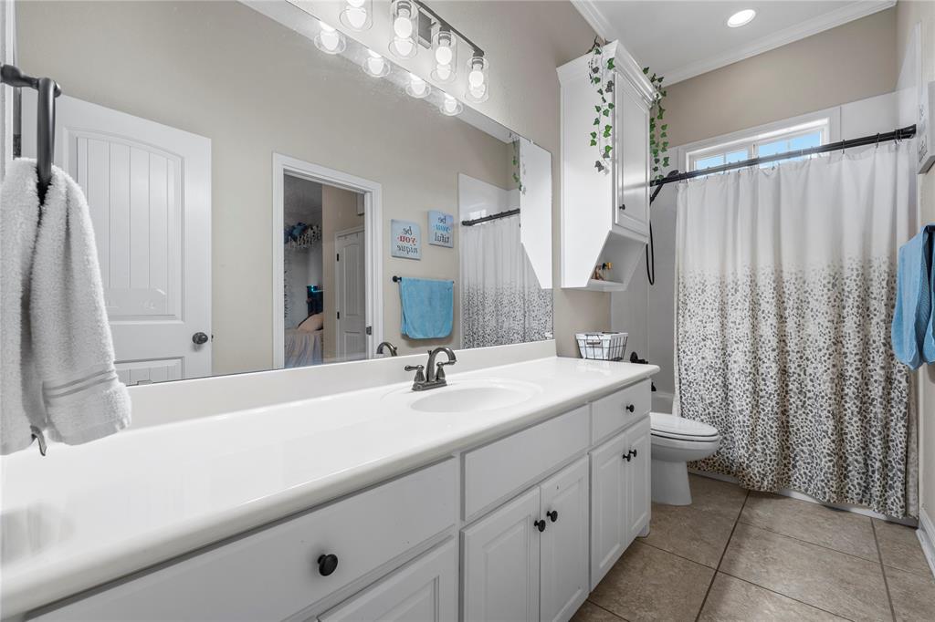 201 Camino Del Rancho Lorena, TX 76655 - Photo 25 of 35 a bathroom with a double vanity sink mirror and toilet