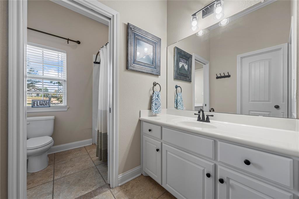 201 Camino Del Rancho Lorena, TX 76655 - Photo 26 of 35 a en suite bathroom with a granite countertop sink toilet and mirror