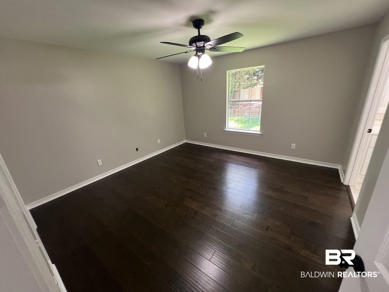 266 Ridgewood Drive Daphne, AL 36526 - Photo 11 of 34 Spacious room featuring rich wood-finish flooring, neutral wall tones, and white baseboards