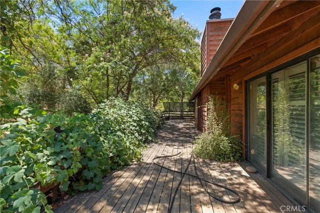 an empty room with windows and ceiling fan