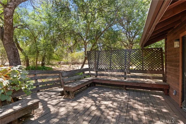 a view of empty room with wooden cabinet and windows