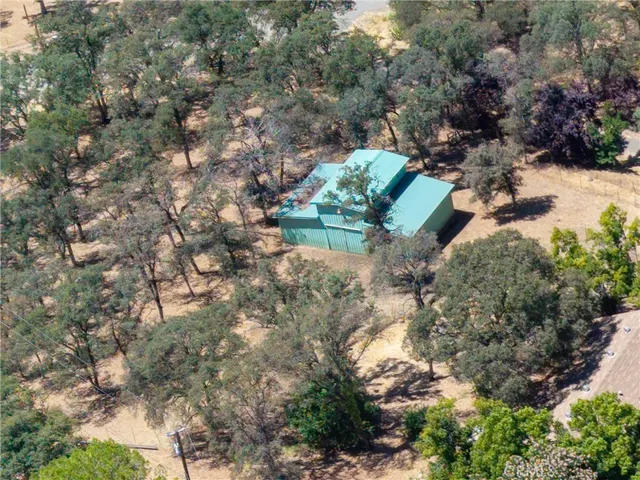 an aerial view of a house with a yard and lake view