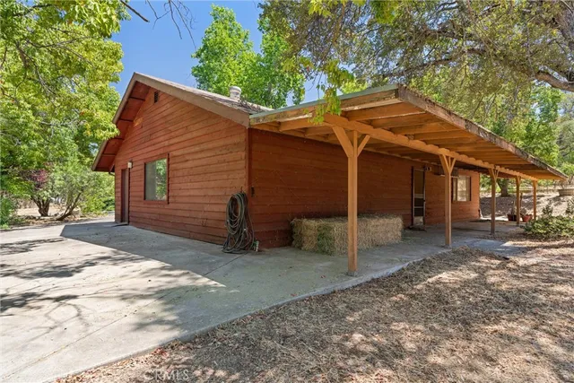 a view of a house with a tree in front