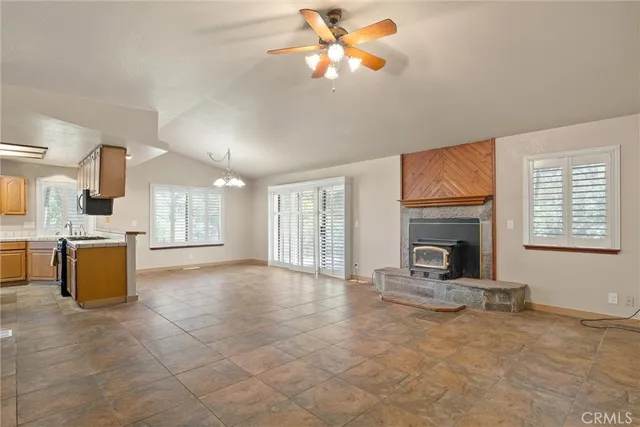 a kitchen with stainless steel appliances granite countertop a refrigerator a stove and a sink