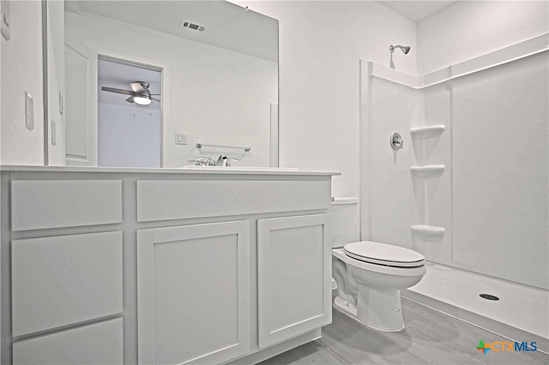 11806 Bluebell Ridge Converse, TX 78109 - Photo 14 of 20 a bathroom with a sink a toilet and shower