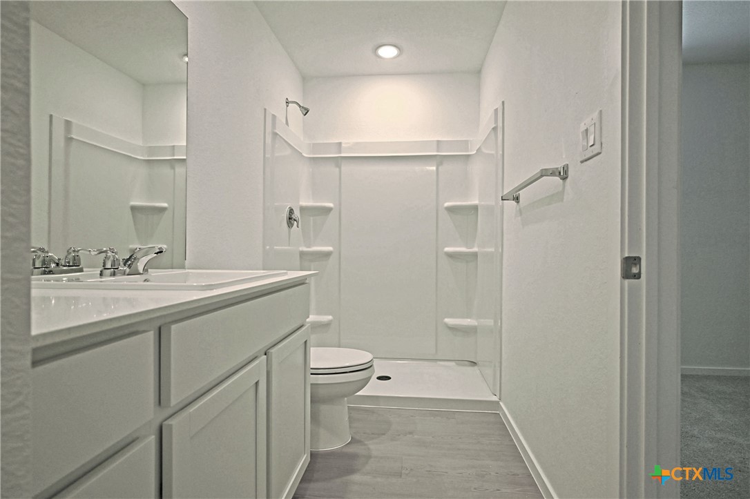 11806 Bluebell Ridge Converse, TX 78109 - Photo 15 of 20 a bathroom with a granite countertop sink toilet and shower