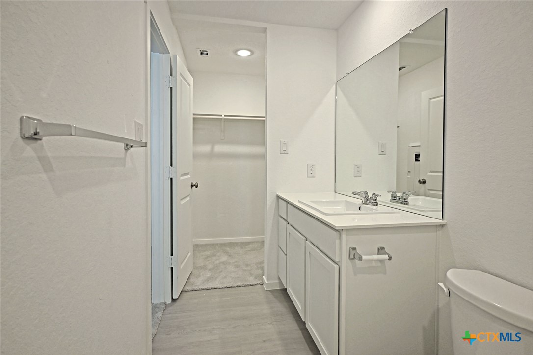 11806 Bluebell Ridge Converse, TX 78109 - Photo 16 of 20 a bathroom with a sink a toilet and shower