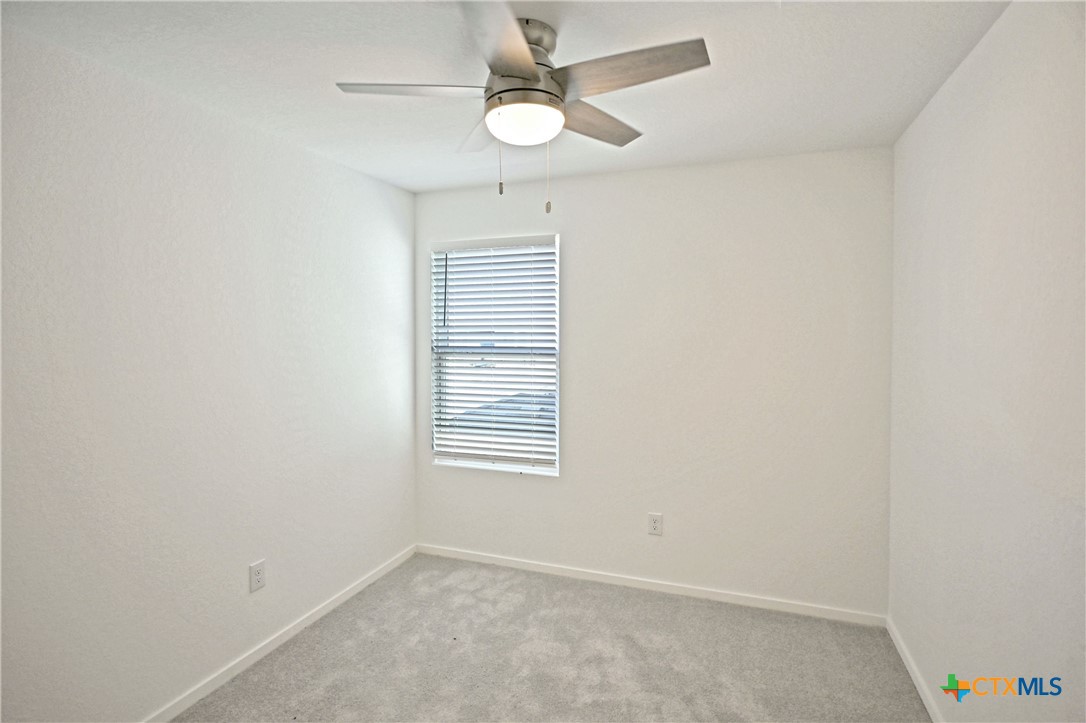 11806 Bluebell Ridge Converse, TX 78109 - Photo 18 of 20 an empty room with windows and fan