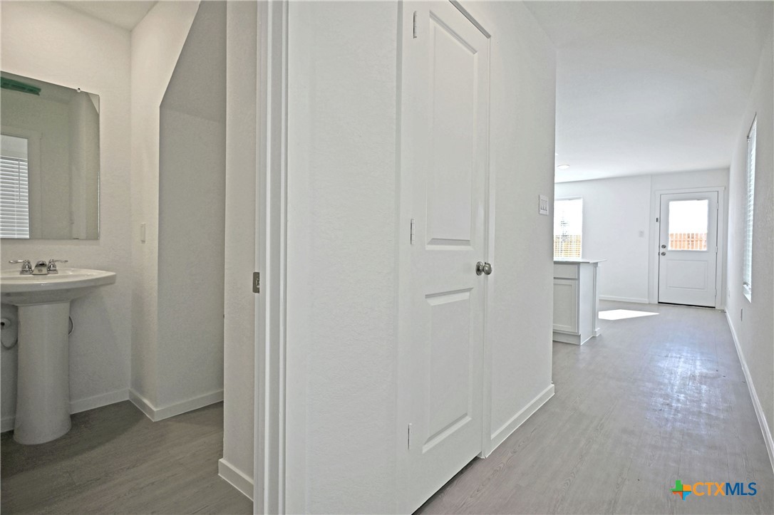 11806 Bluebell Ridge Converse, TX 78109 - Photo 3 of 20 a view of a hallway with bathroom and sink