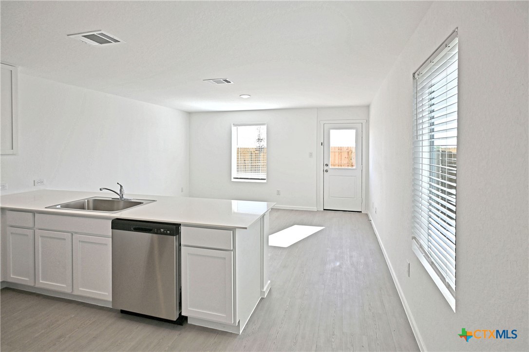 11806 Bluebell Ridge Converse, TX 78109 - Photo 4 of 20 a view of a kitchen with white cabinets