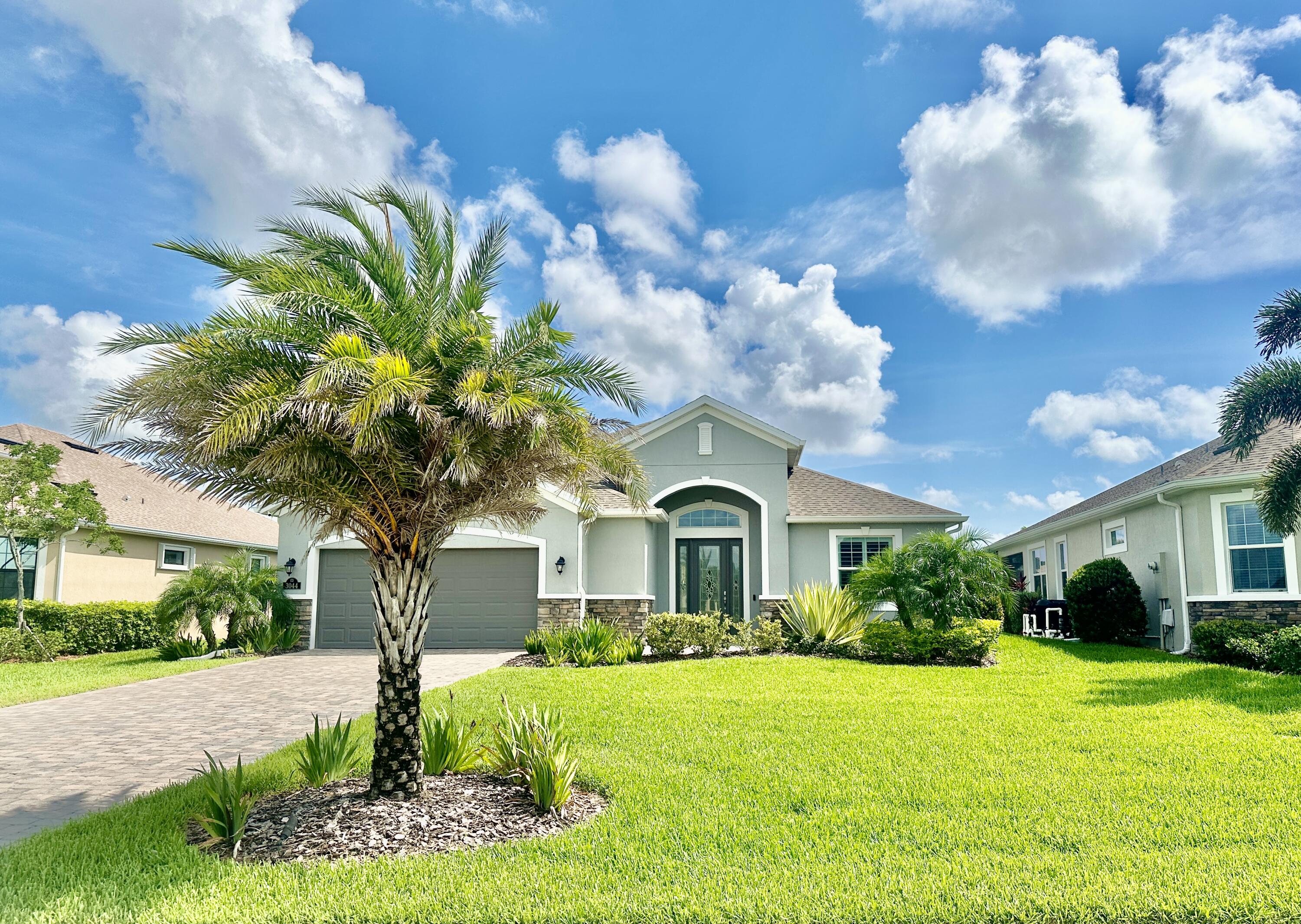 a front view of a house with a yard and garage