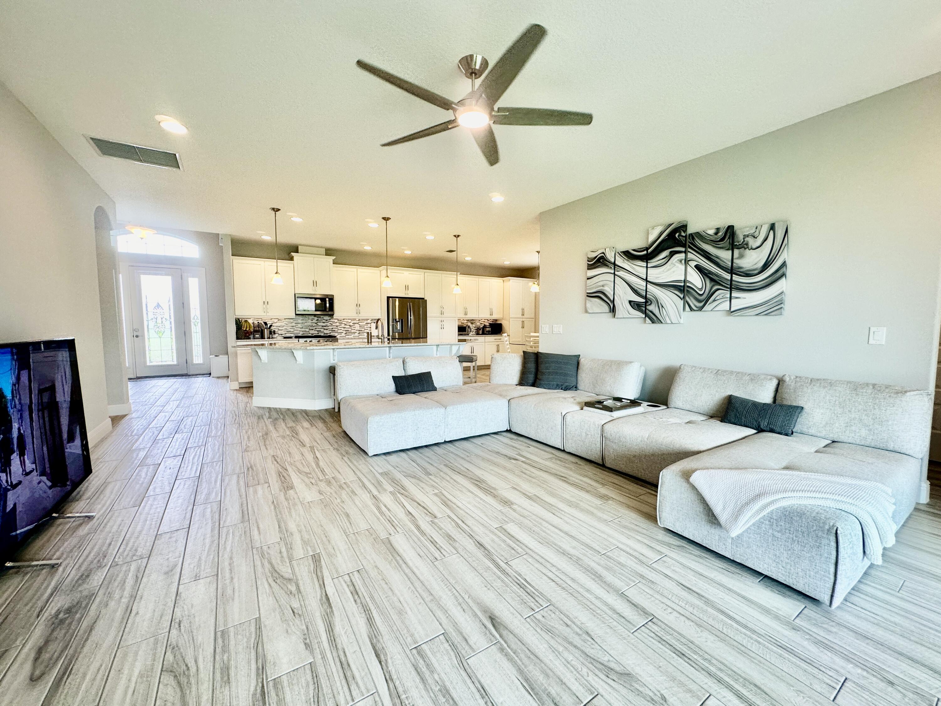 3044 Trasona Drive Melbourne, FL 32940 - Photo 13 of 36 a living room with furniture and wooden floor