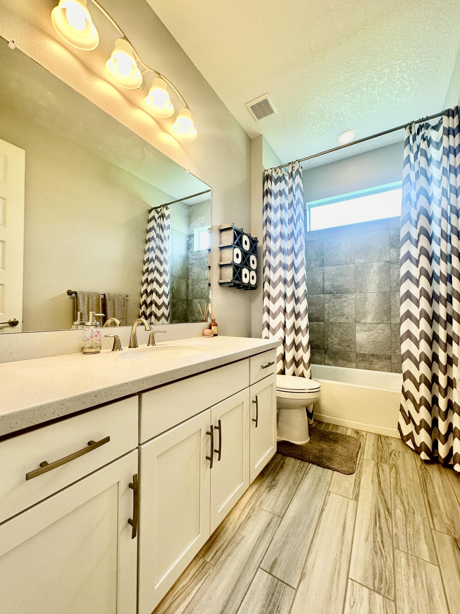 3044 Trasona Drive Melbourne, FL 32940 - Photo 21 of 36 a bathroom with a double vanity sink toilet and shower