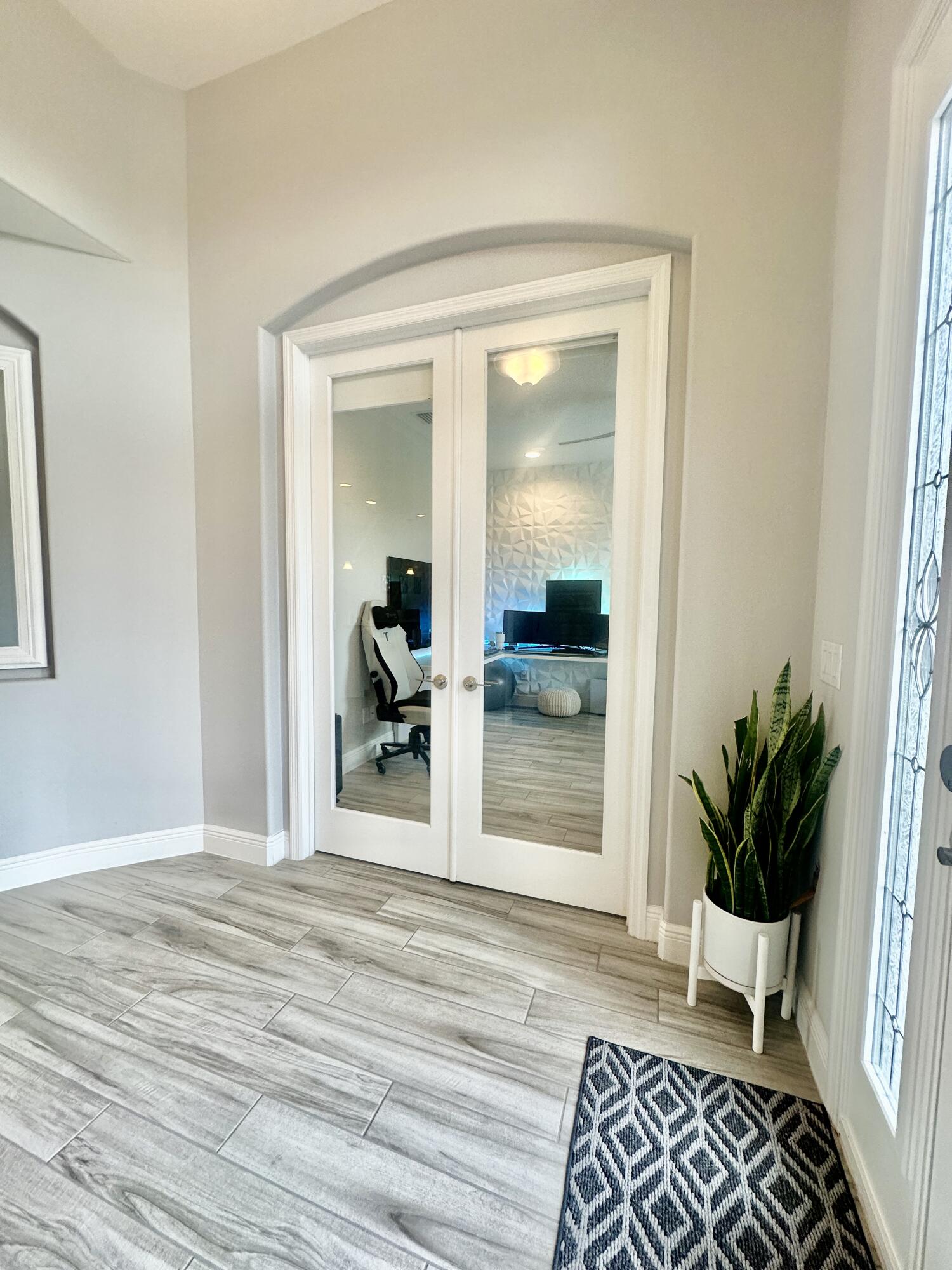 3044 Trasona Drive Melbourne, FL 32940 - Photo 24 of 36 a view of an entryway with wooden floor and a rug
