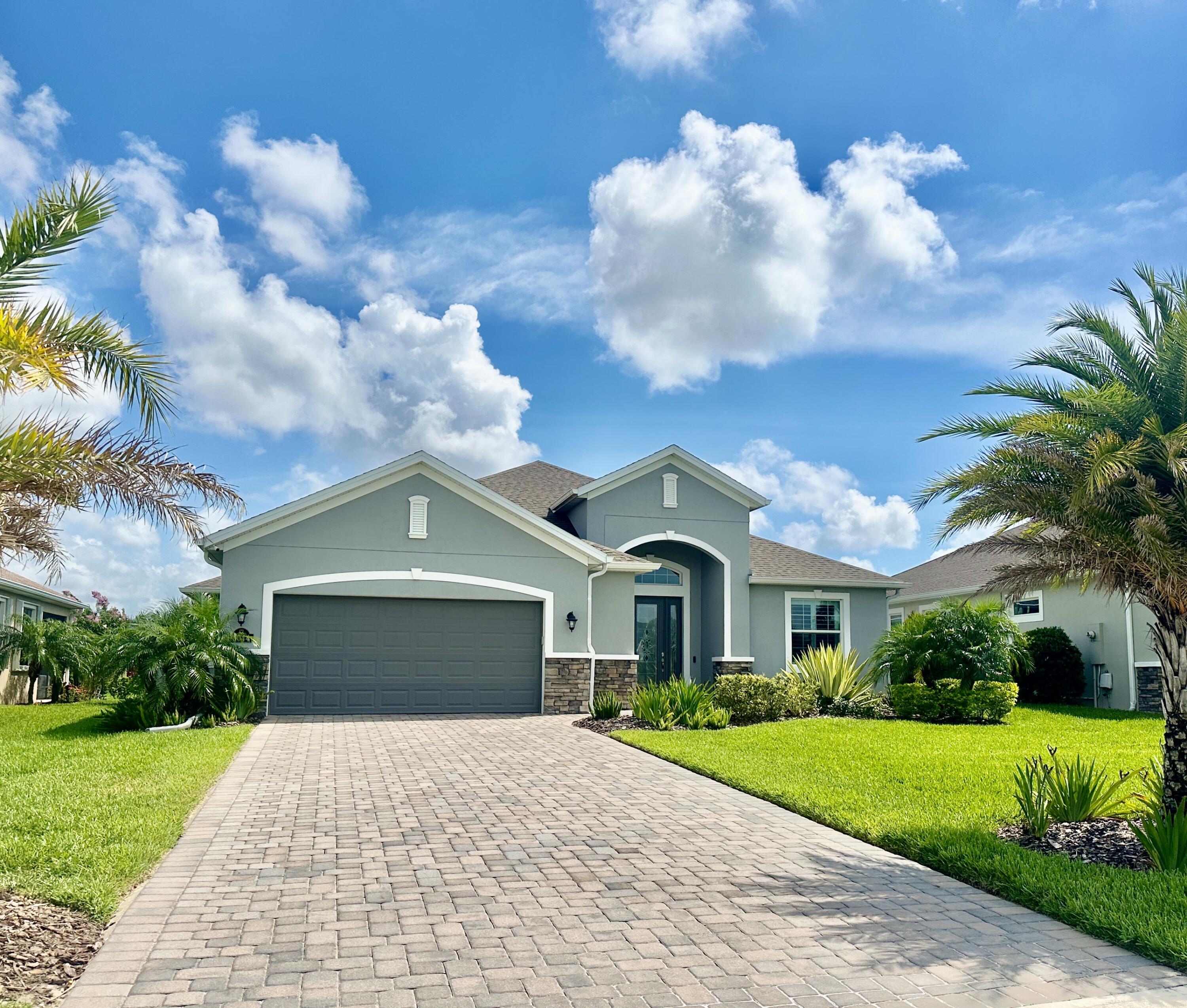 3044 Trasona Drive Melbourne, FL 32940 - Photo 3 of 36 a front view of a house with garden