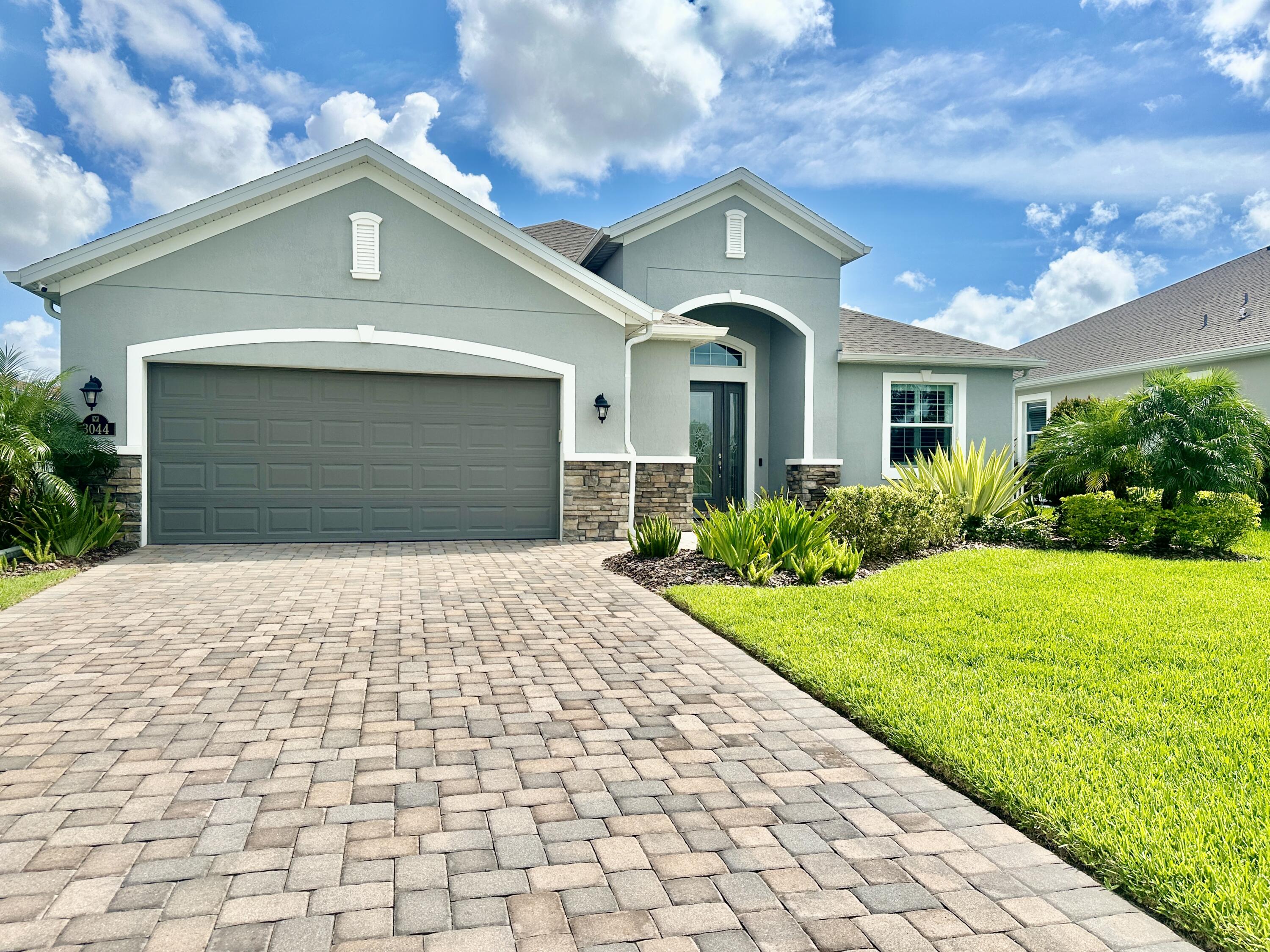 3044 Trasona Drive Melbourne, FL 32940 - Photo 4 of 36 a front view of a house with garden