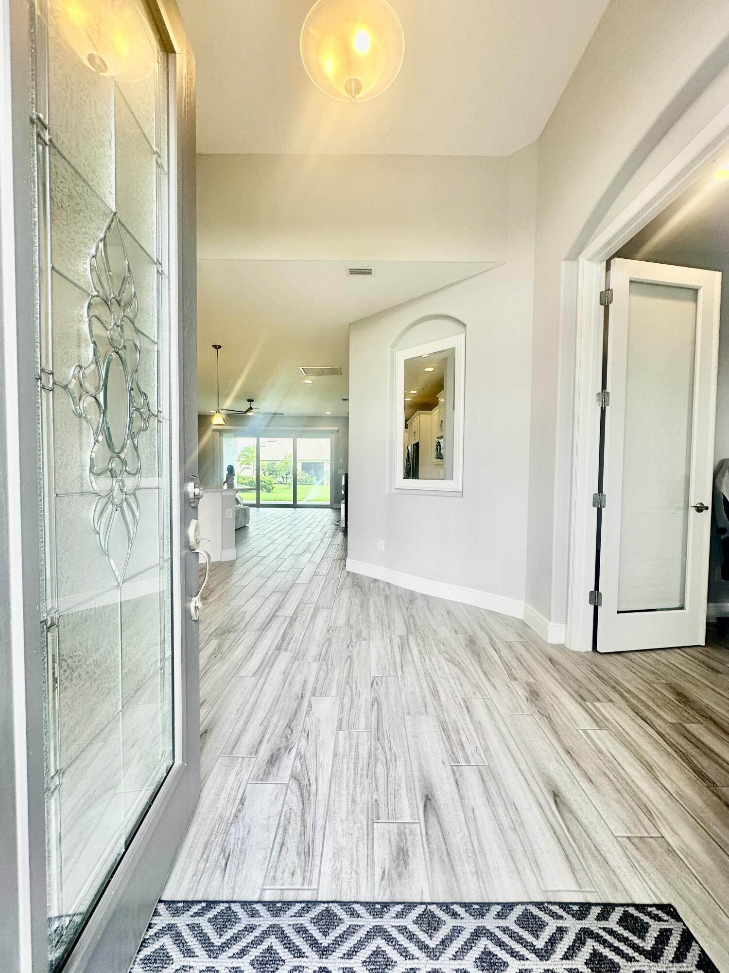 3044 Trasona Drive Melbourne, FL 32940 - Photo 5 of 36 a view of a room with wooden floor and a bathroom