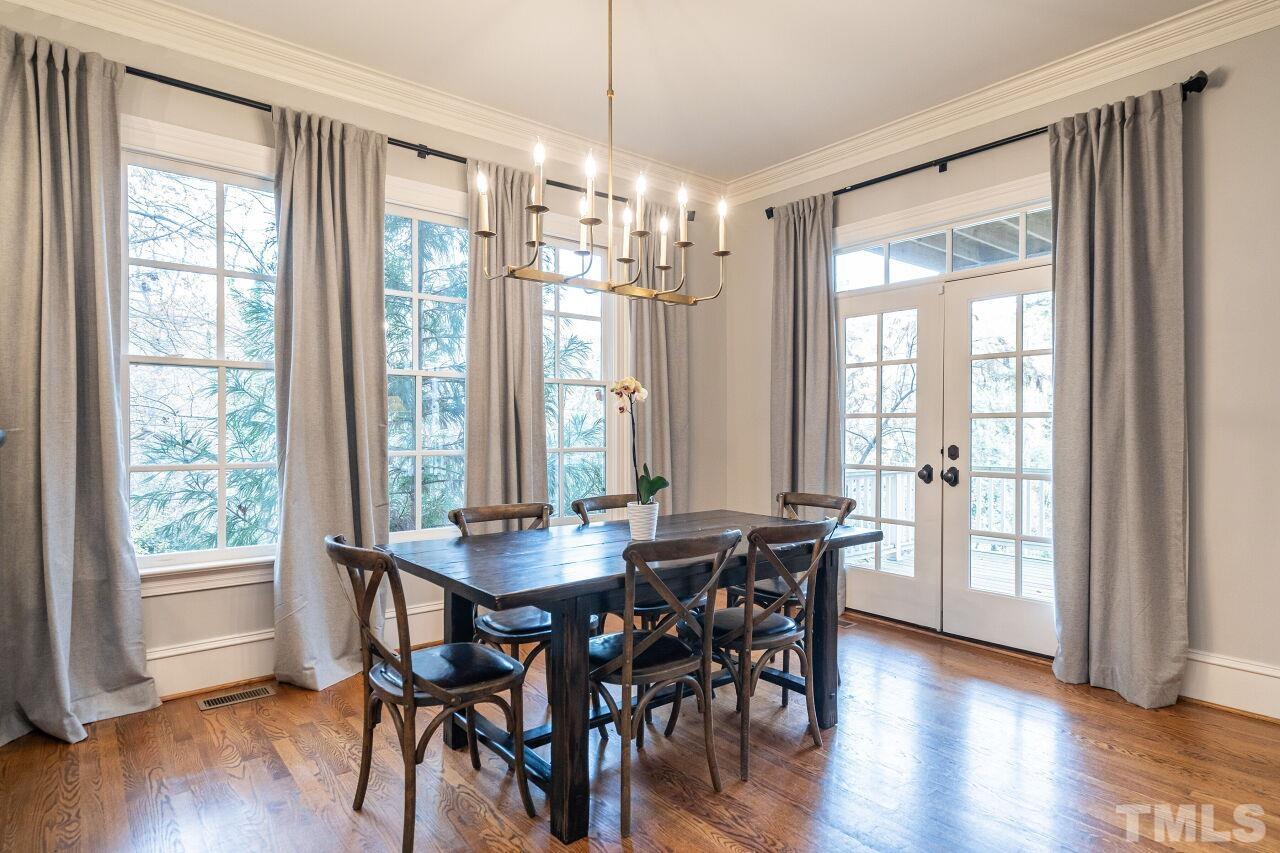 3056 Lewis Farm Road Raleigh, NC 27607 - Photo 13 of 43 a view of a dining room with furniture and wooden floor