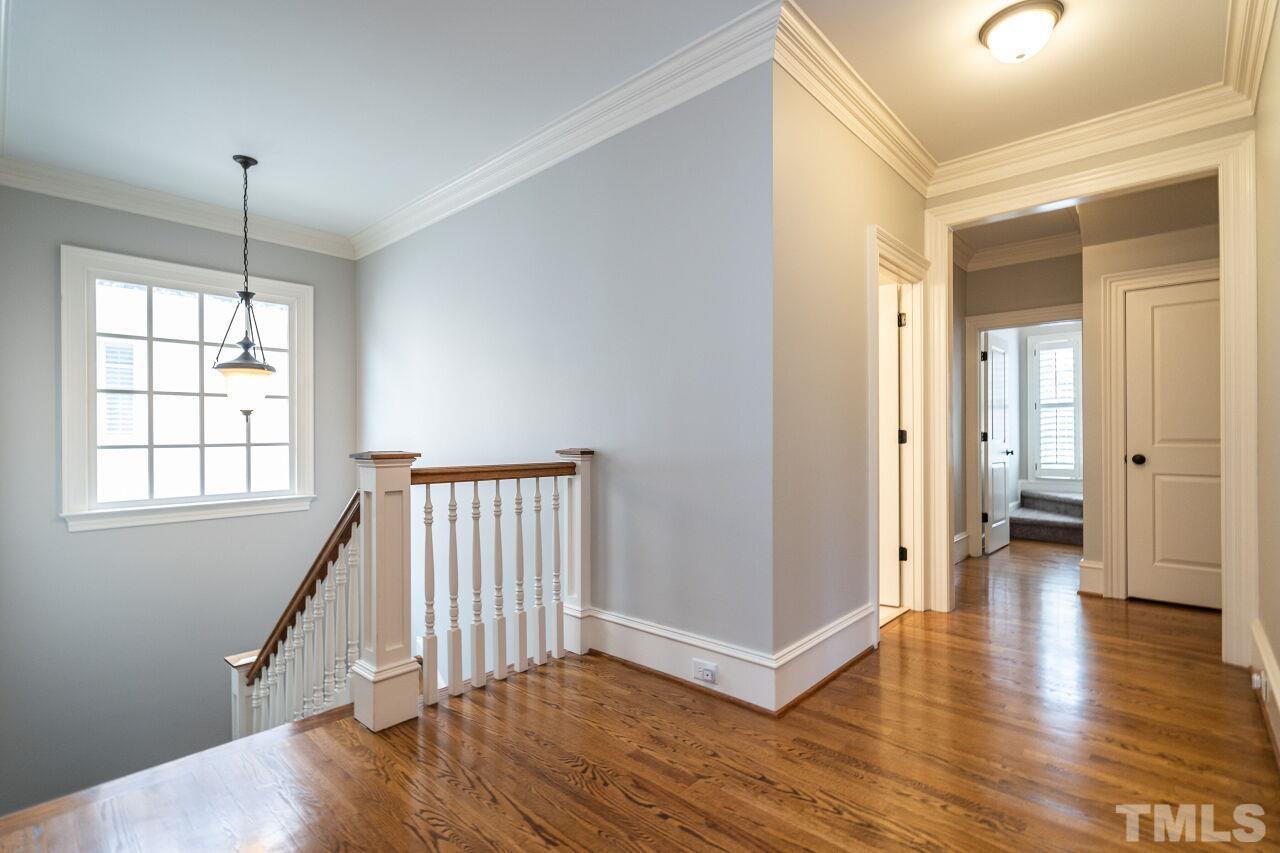 3056 Lewis Farm Road Raleigh, NC 27607 - Photo 20 of 43 a view of a hallway with wooden floor and a window