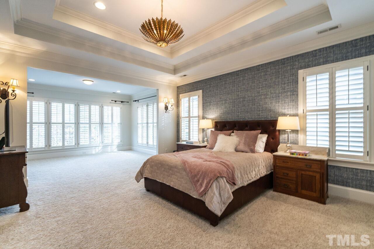 3056 Lewis Farm Road Raleigh, NC 27607 - Photo 21 of 43 a spacious bedroom with a bed and a large window